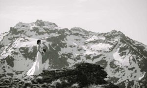 Bride standing on a hill