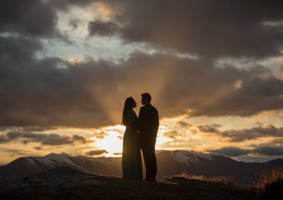 Couple looking at each other in front of sunset