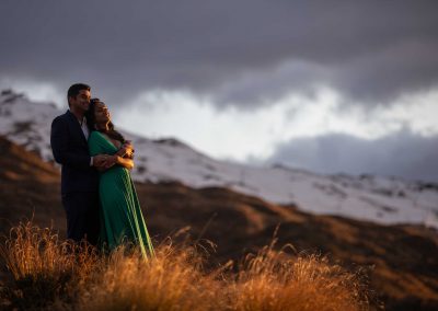 couple hugging with mountain in background