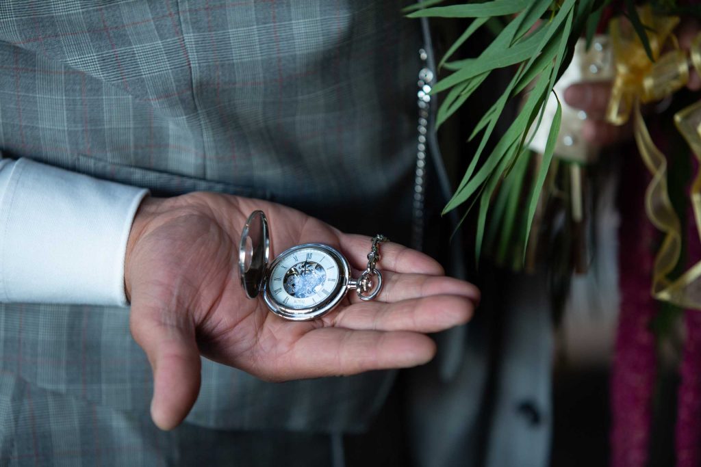 hand holding a pocket watch
