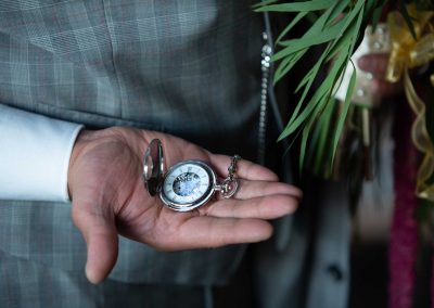 hand holding a pocket watch