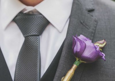 close up of groom's buttonhole flower