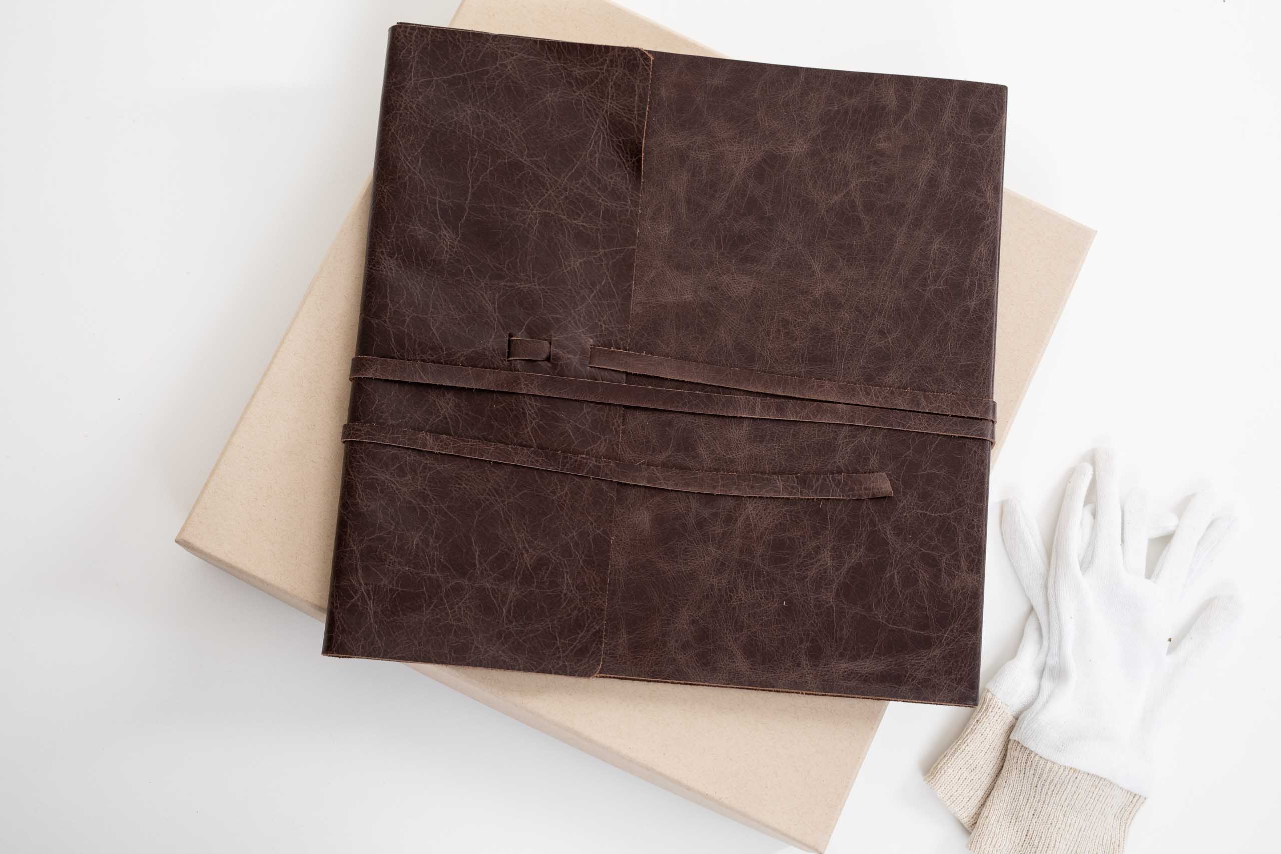 brown leather album, with white gloves