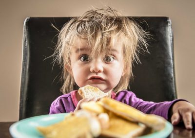 portrait of young girl eating toast