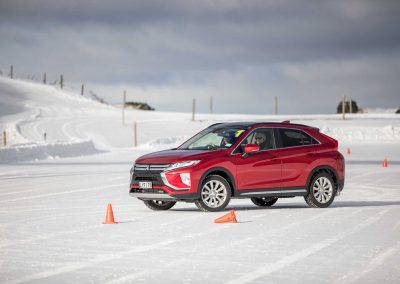 red car driving on snow