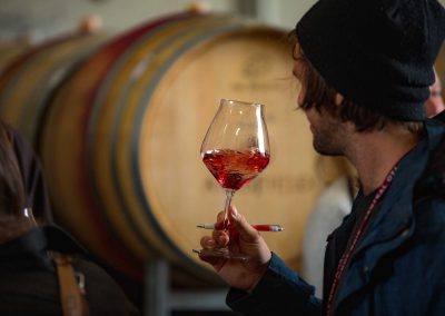 male swirling a glass of wine