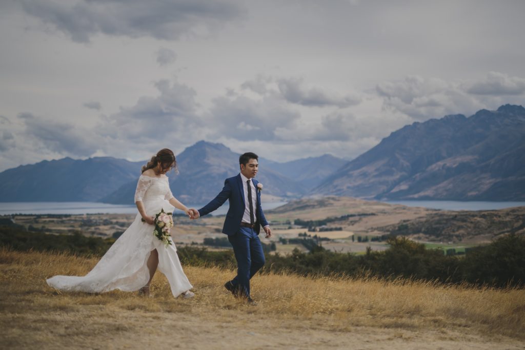 Bride and groom walking in countryside