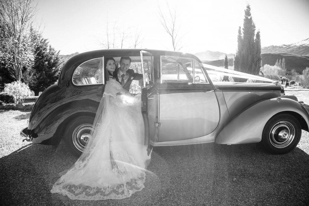 bride and groom in car