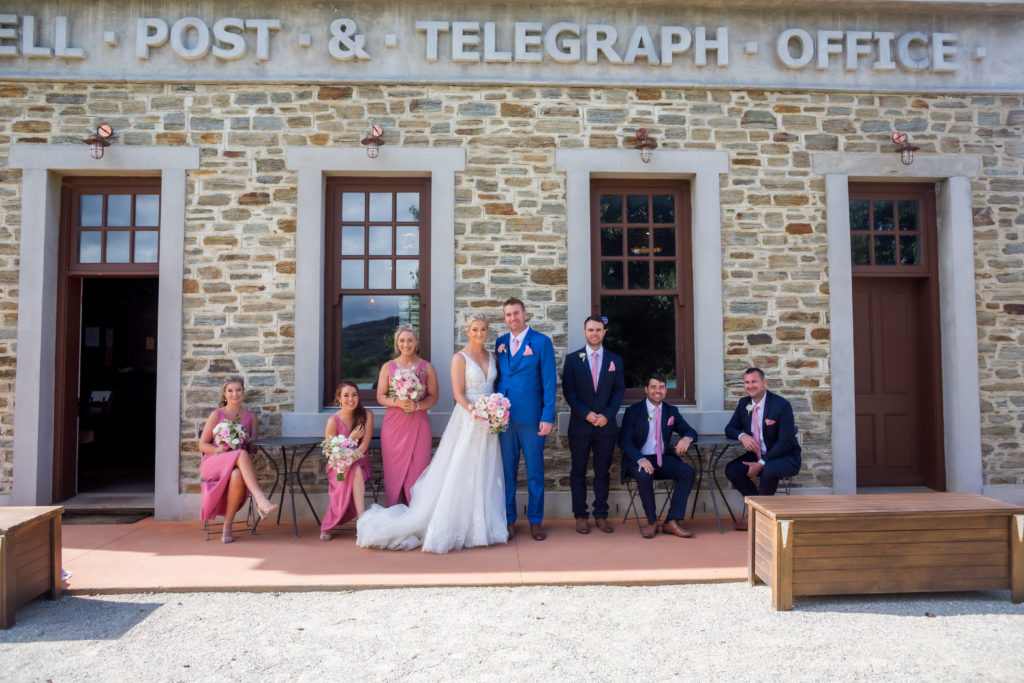 Wedding group in front of old building for group portrait