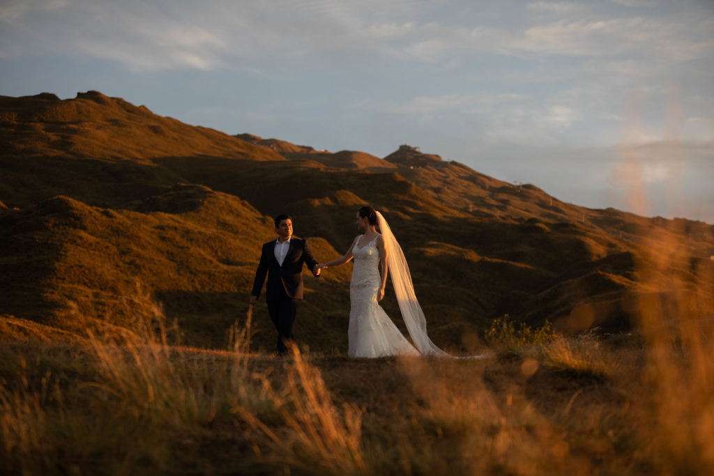 Bride and groom in countryside at sunrise