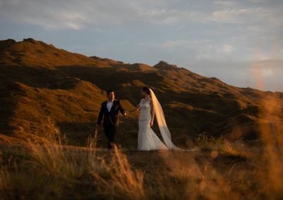 Bride and groom in countryside at sunrise