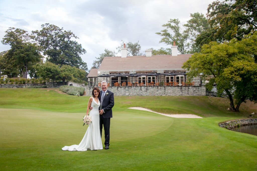 Bride and groom standing infront of Millbrook venue