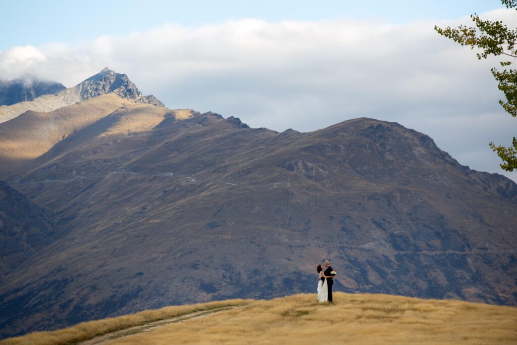 Bride and groom on hill top