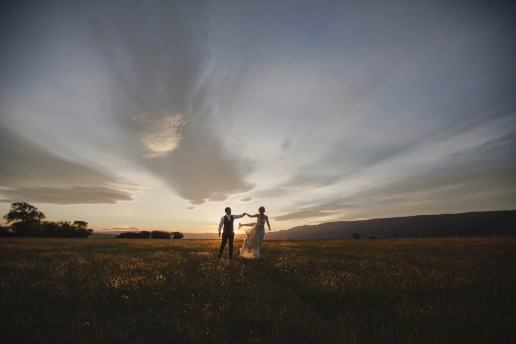 Bride and groom dancing in the sunset