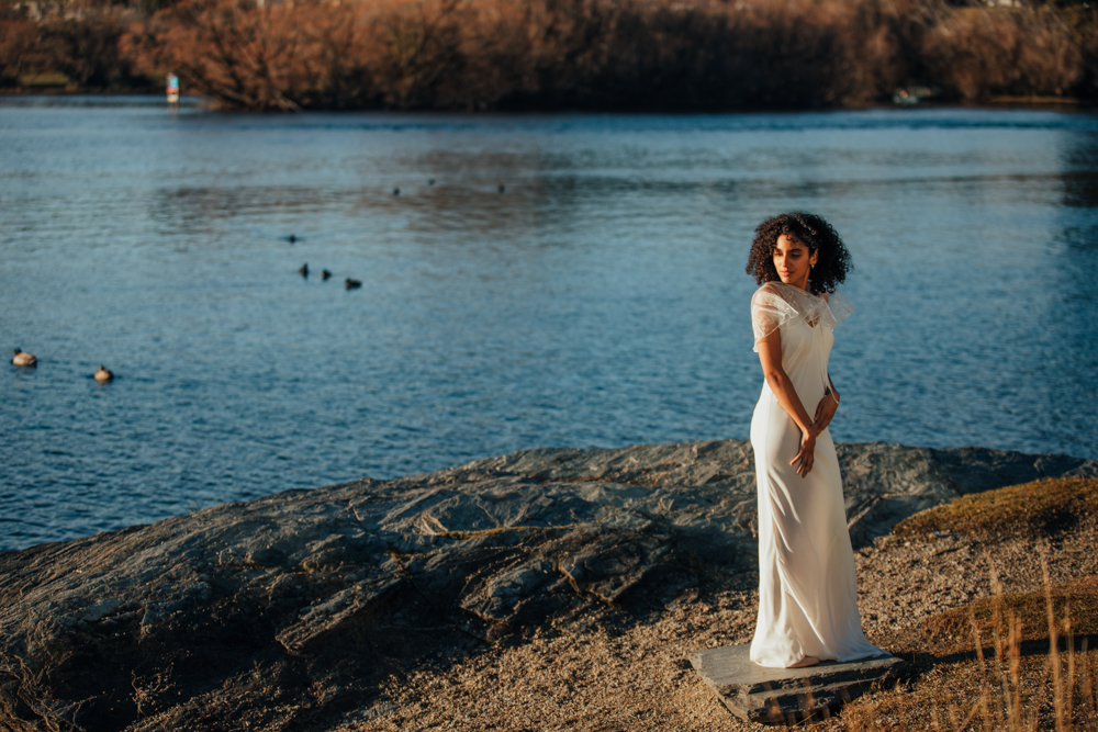 Bride standing by lake