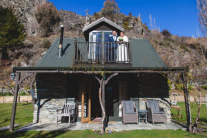 Bride and groom on balcony of small house