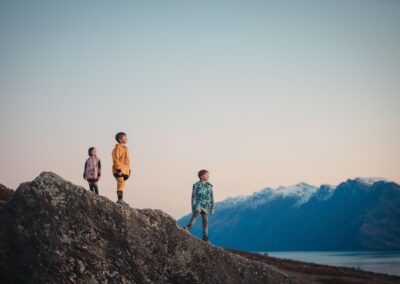 children standing on a hill