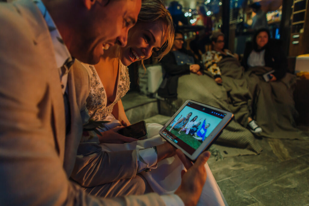 man and woman watching video on ipad