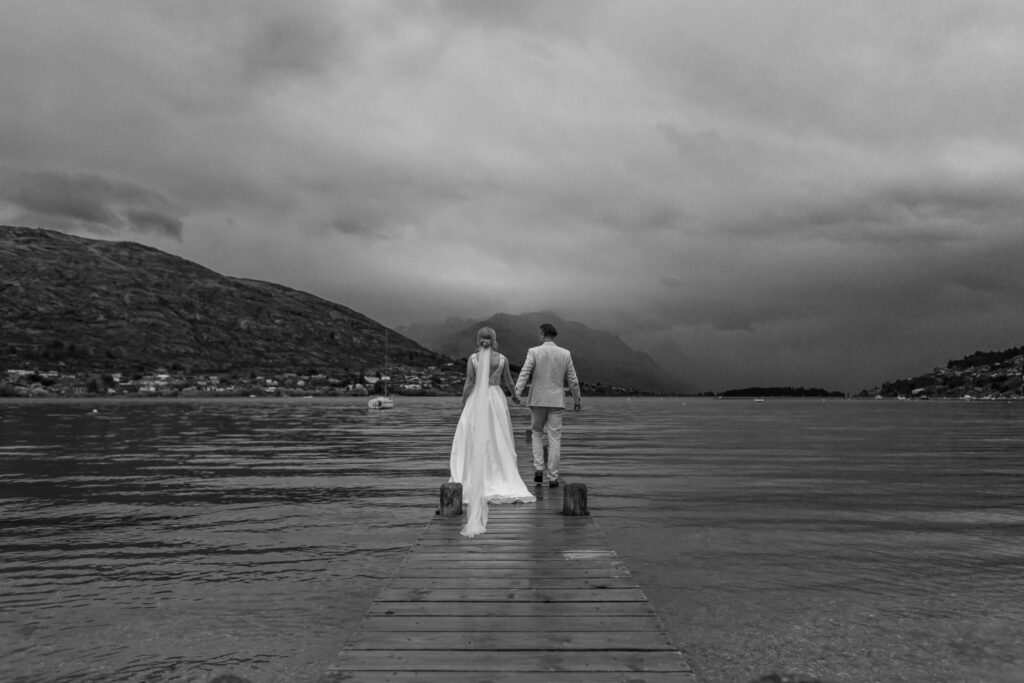 Bride and groom standing on jetty