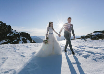bride and groom on snowy mountain