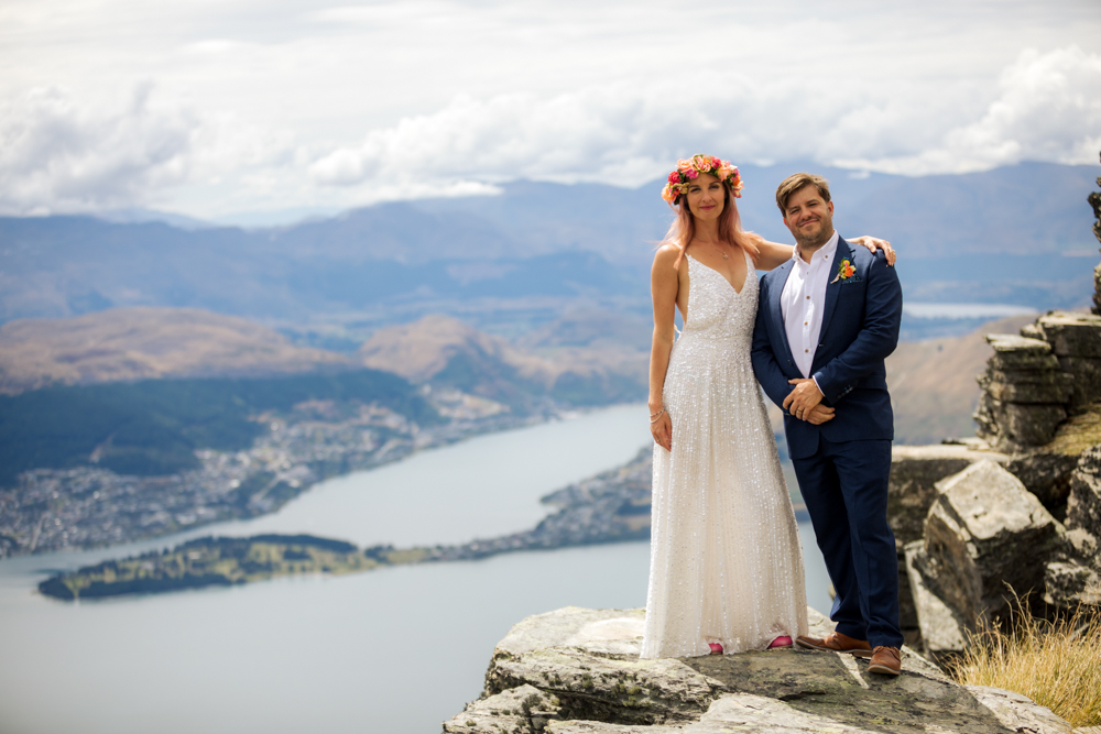 bride and groom on mountain ledge