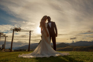 bride and groom with mountains behind