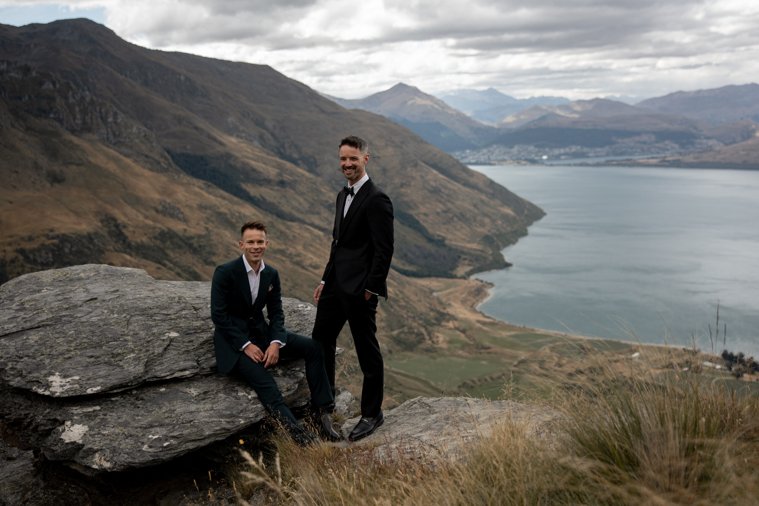 Joel and James standing on Bayonets with Queenstown in the background